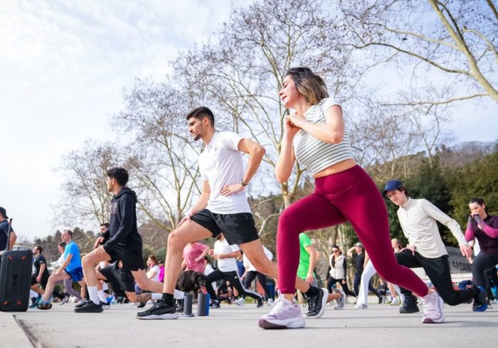 Group of adults in a fitness class outdoors in İstiklal Park, İstanbul.
